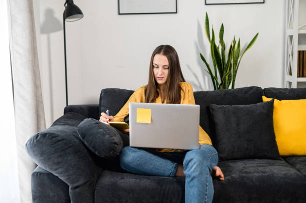 istock A young woman with a laptop at home 1314807581