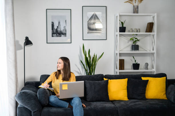 istock A young woman with a laptop at home 1314807651