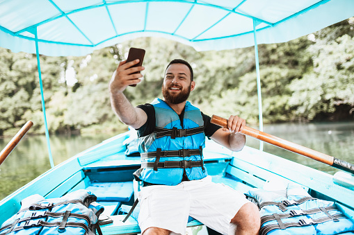 Selfie Time For Bearded Male Rowing Boat On Lake