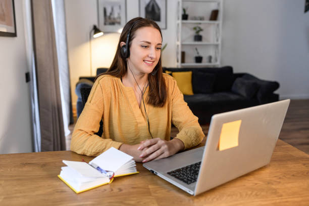 istock A young woman with a laptop at home 1314808506
