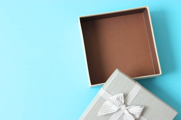 istock open gift box and confetti on a colored background top view. 1314810485