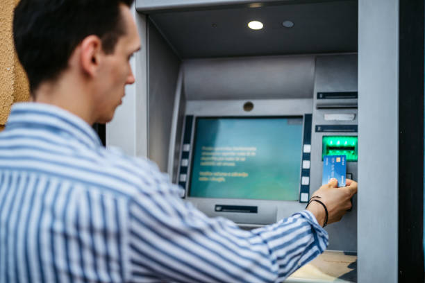 istock Man withdrawing money at ATM 1314810556