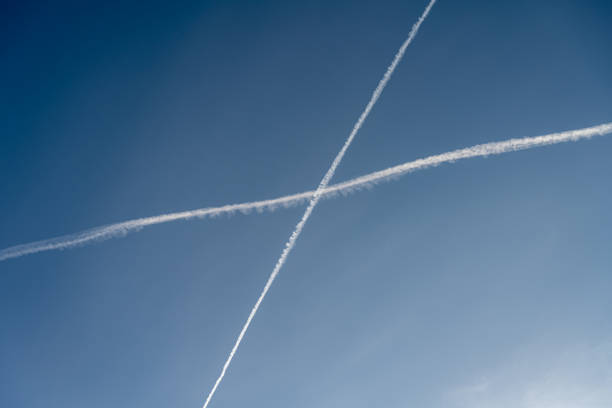 istock White trails, from jet exhaust, form a cross in the sky 1314810626