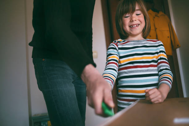 istock Father and son opening delivery box at home 1314810850