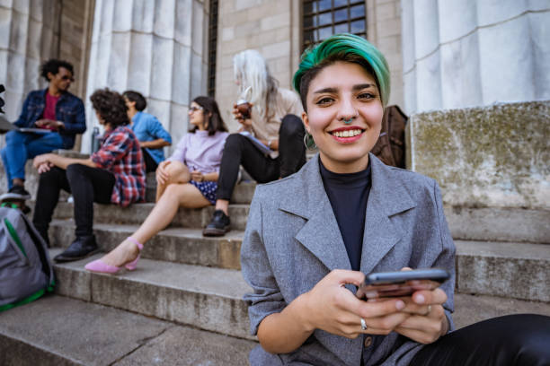 Young woman using phone on stairs