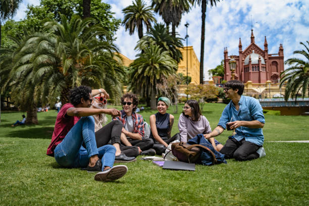 istock Professor lecturing to students in park 1314812208