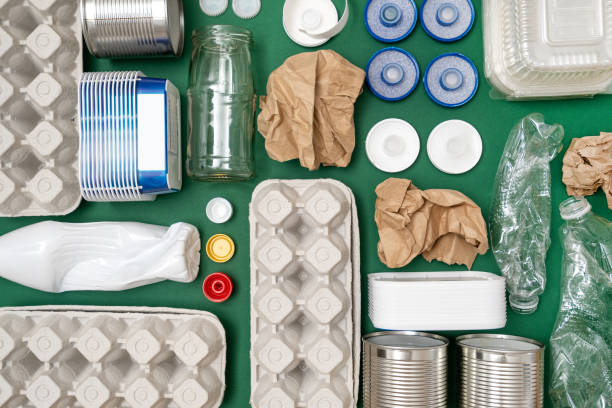 istock Plastic, paper, glass, metal garbage on green background 1314812212