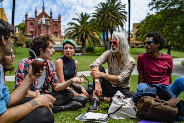 istock Professor lecturing to students in park 1314812266
