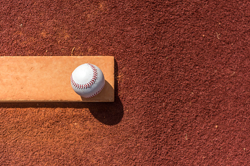 Beautiful morning to play baseball. Baseball equipment on the ground.