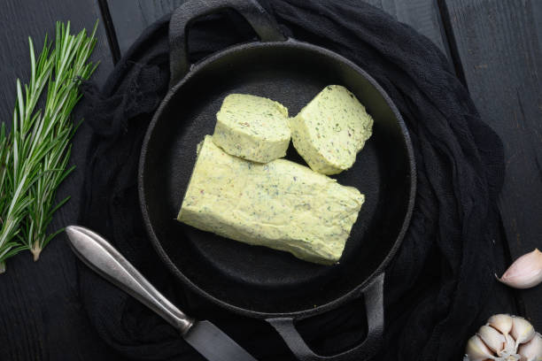 istock Fresh green herb butter, on black wooden table background 1314818110