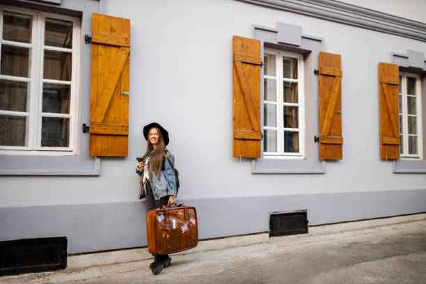 Female tourist surfing the net on the street
