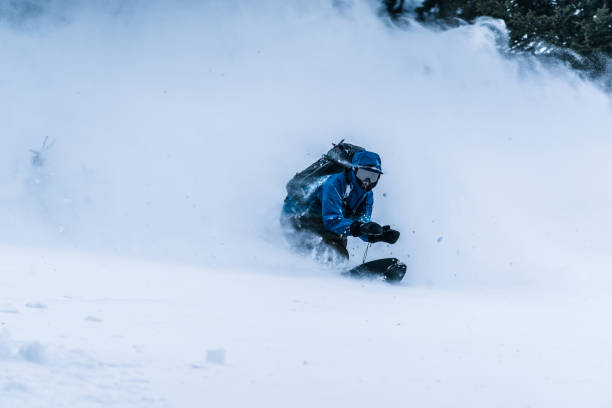 istock Splitboarder descends a steep powder slope in the mountains 1314820119
