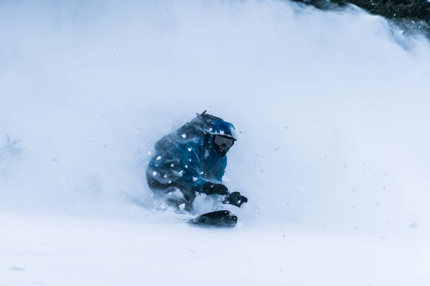 istock Splitboarder descends a steep powder slope in the mountains 1314820120