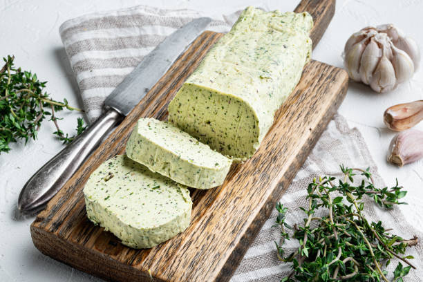 istock Dairy green butter with herbs, on white stone  background 1314821649