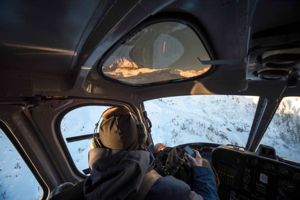 istock Skier flies in helicopter over snowcapped mountains 1314821732