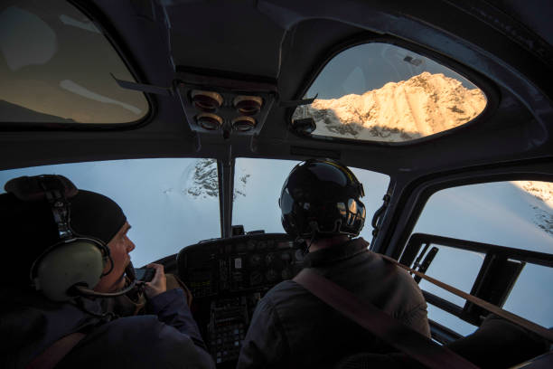 istock Skiers fly in helicopter over snowcapped mountains 1314821785