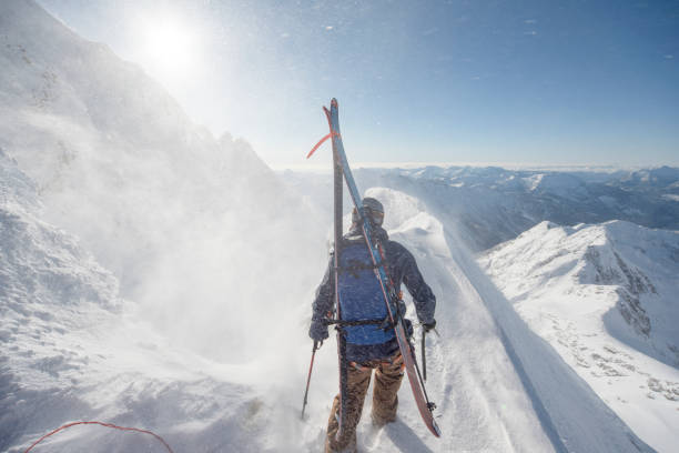 istock Ski mountaineer climbs snowy mountain pinnacle 1314821873