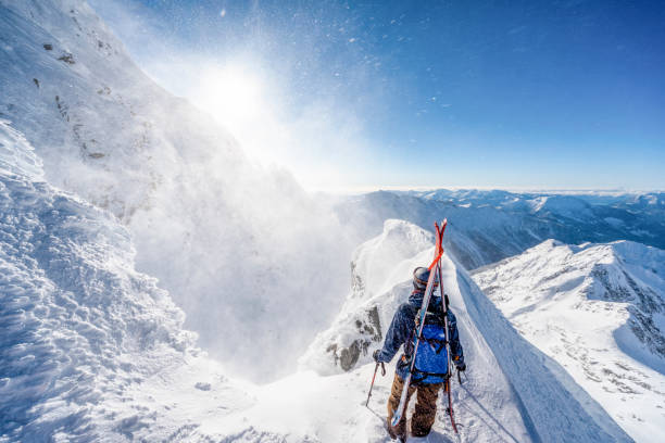 istock Ski mountaineer climbs snowy mountain pinnacle 1314821914