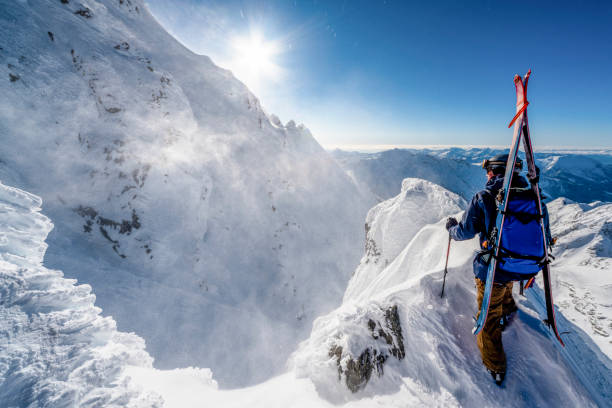 istock Ski mountaineer climbs snowy mountain pinnacle 1314821958