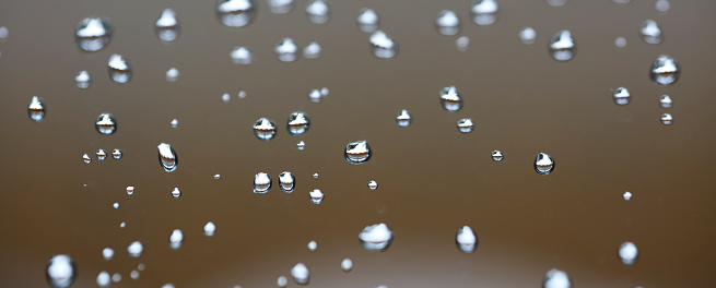 Water drops on the  brown background,