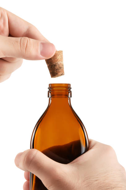 istock Men's hand opening a drink bottle (Clipping Path) on the white background 1314827081