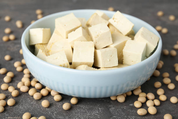 istock Cut tofu and soya beans on grey table, closeup 1314827409