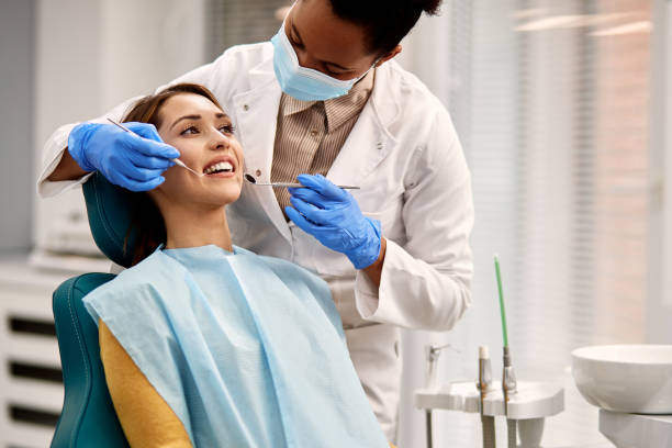 istock Smiling woman getting her teeth checked during dental appointment at dentist's office. 1314827953