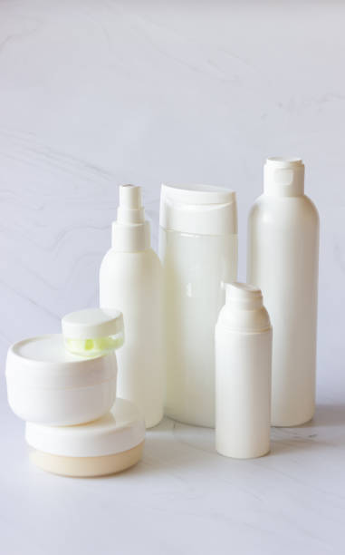 istock White bottles and cans for cosmetics on a light background. Clean, layout and template 1314827972