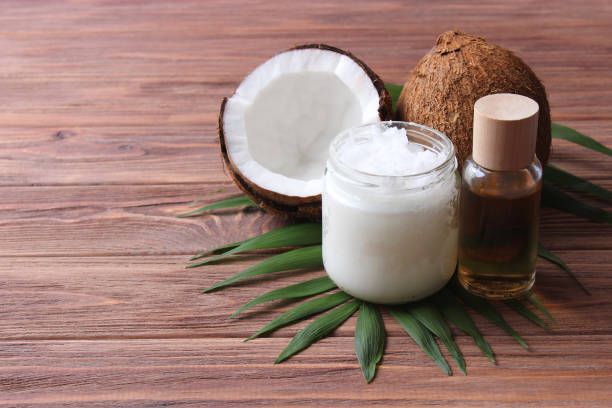 istock coconut oil and coconuts, palm branches close up 1314828982