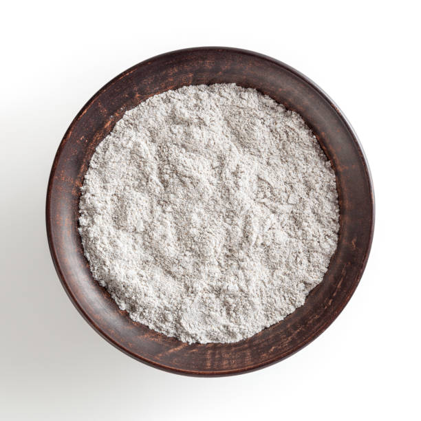 Rye flour in ceramic bowl isolated on white background with clipping path
