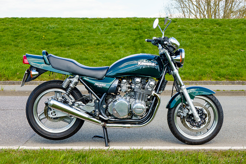 Hamburg, Germany - March, 11. 2021: Kawasaki Zephyr 750 youngtimer motorcycle, parked on a country road on a sunny summer day in Hamburg, Germany. The uncovered machines (so-called “naked bikes”) were available in Germany from 1991 to 2000 in the 550, 750, and 1100 cm³ versions, which were supposed to be reminiscent of the Z models from the 1970s. They were all air-cooled 4-cylinder 4-stroke engines