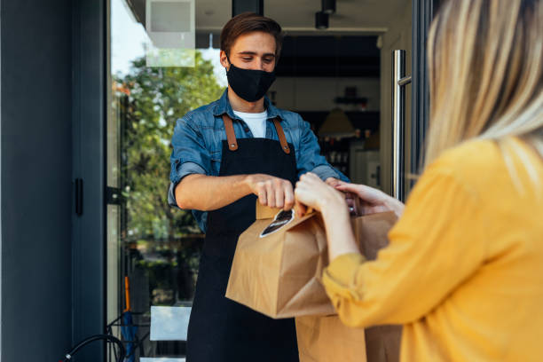 istock Customer pick up takeout food order from waiter 1314831633