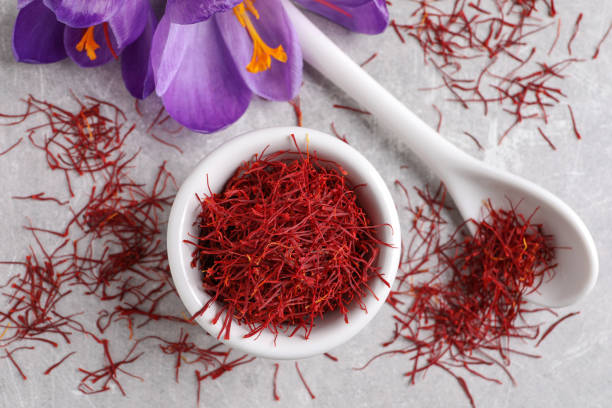istock Dried saffron and crocus flowers on grey table, flat lay 1314832586