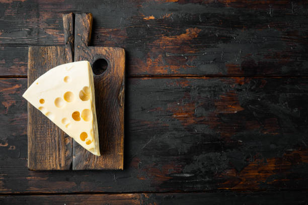 istock Maasdam cheese, on old dark  wooden table , top view flat lay, with copy space for text 1314834728