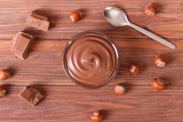 istock chocolate paste in a glass jar on a colored background. 1314838880