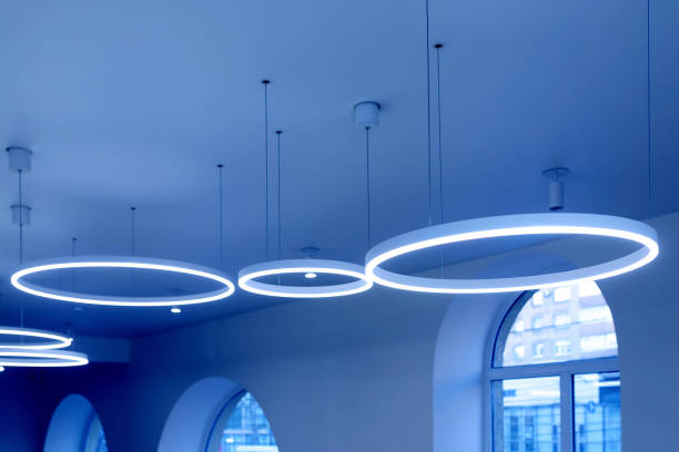 istock Ceiling with round modern LED lamps. Suspended fluorescent lights under the ceiling. Careful energy consumption, energy saving concept 1314839144