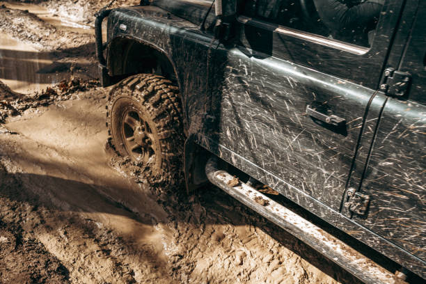 istock Offroad car driving through the forest road of mud 1314841796