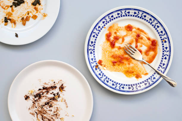 istock Dirty plate with cake leftovers and fork on gray background, top view 1314843029