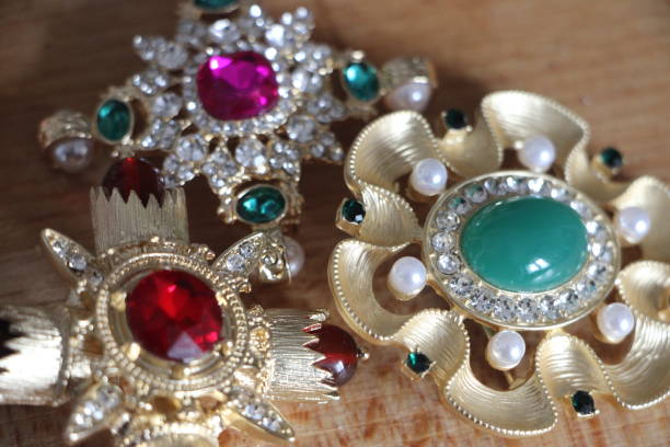 istock Jewelry brooches with emerald, peals and other gems. Selective focus 1314843257