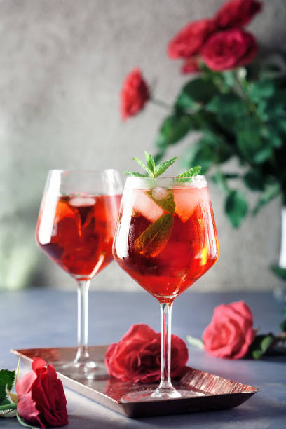 istock Two alcohol cocktails set with red roses 1314845212