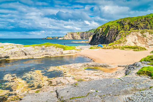 Camping with tents on a beautiful beach in Ballintoy, Northern Ireland.
