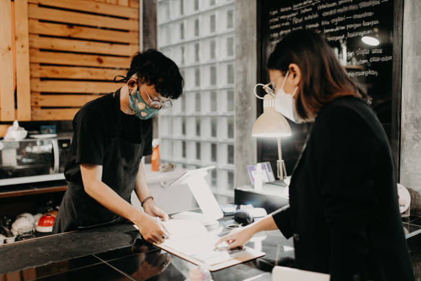 istock woman taking his order at a coffee shop 1314847878