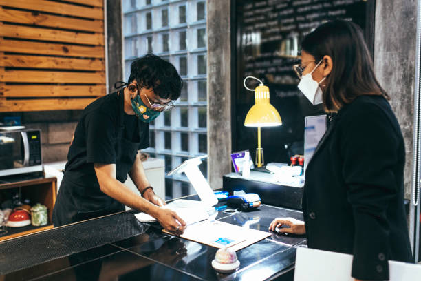 istock woman taking his order at a coffee shop 1314847879