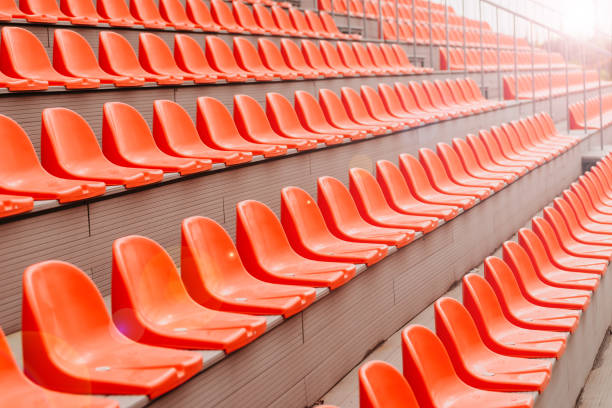 istock Photo of empty orange chairs on stadium, lockdown concept 1314848214