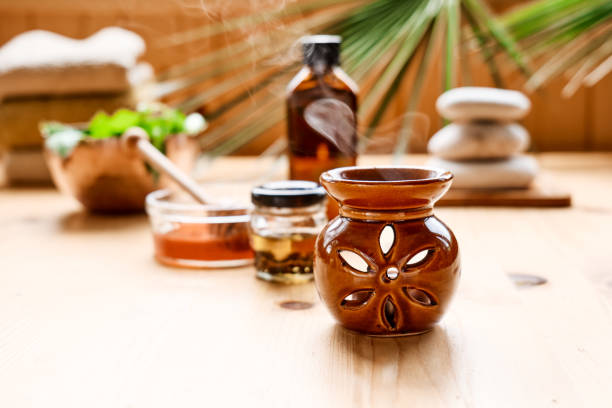 Essential oil diffuser, medical herbs, different types of oils and essences on the table. Aromatherapy and alternative medicine concept. Natural remedies.