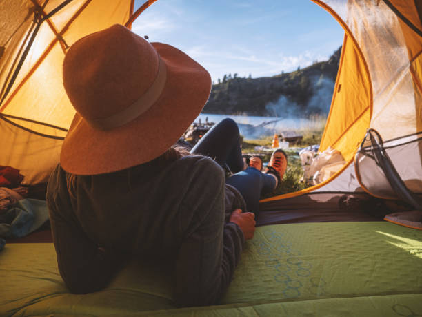 istock Woman camping on mountain top, arms wide open 1314849189