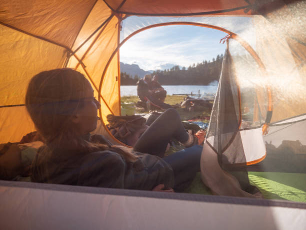 istock Woman camping on mountain top, arms wide open 1314849192