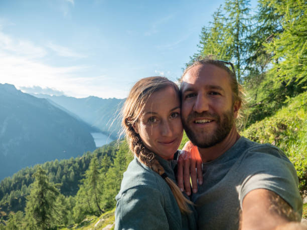 istock Couple take selfie in alpine landscape, Summer 1314849862