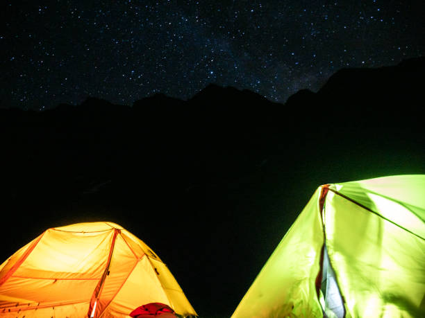 istock Illuminated tents on mountain top, night shot 1314850210