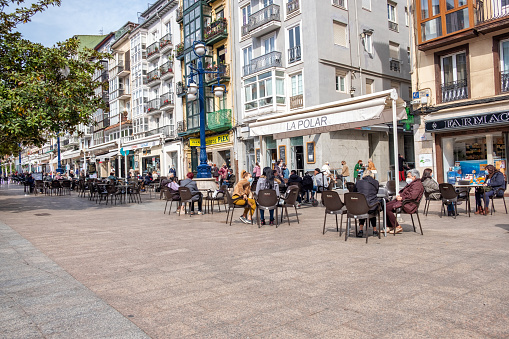 Santander, Cantabria, Spain – Abril 19, 2021: People relax in the sidewalk cafes in Santander